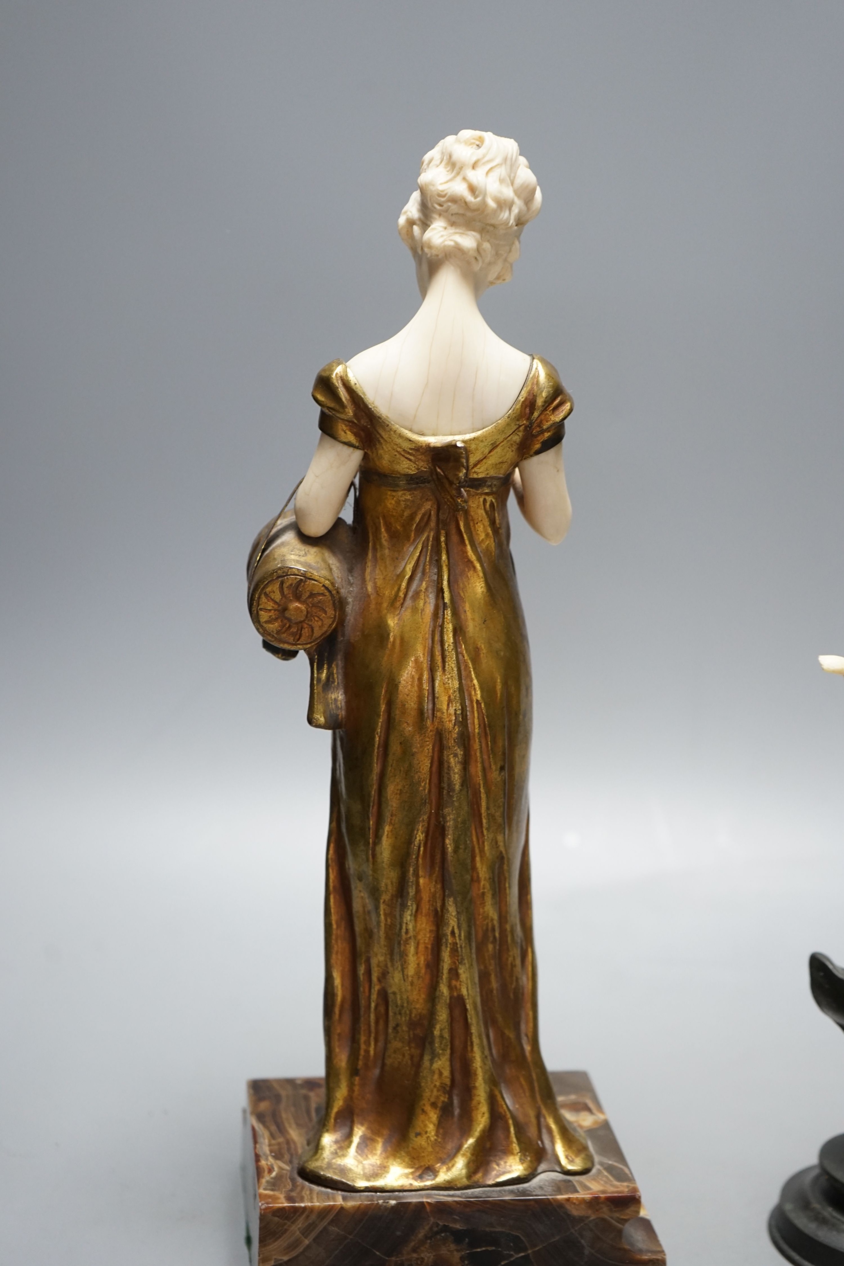 Georges Van Der Straeten, Belgian 1856-1928, An Art Deco bronze and ivory figure of a girl reading a book together with a smaller bronze and ivory figure, Tallest 31.5 cms high.